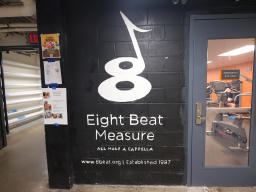 A mural consisting of a white number eight on a black background, stylized to
partially resemble a music note. Below it is the text 