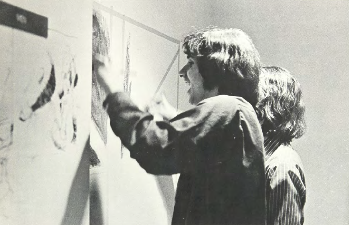 Students joyfully paint graffiti in the tunnels, circa 1970